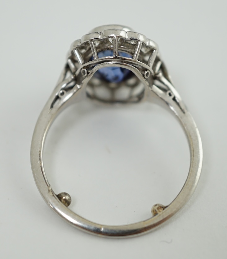 A mid 20th century white gold and millegrain set sapphire and diamond oval cluster ring